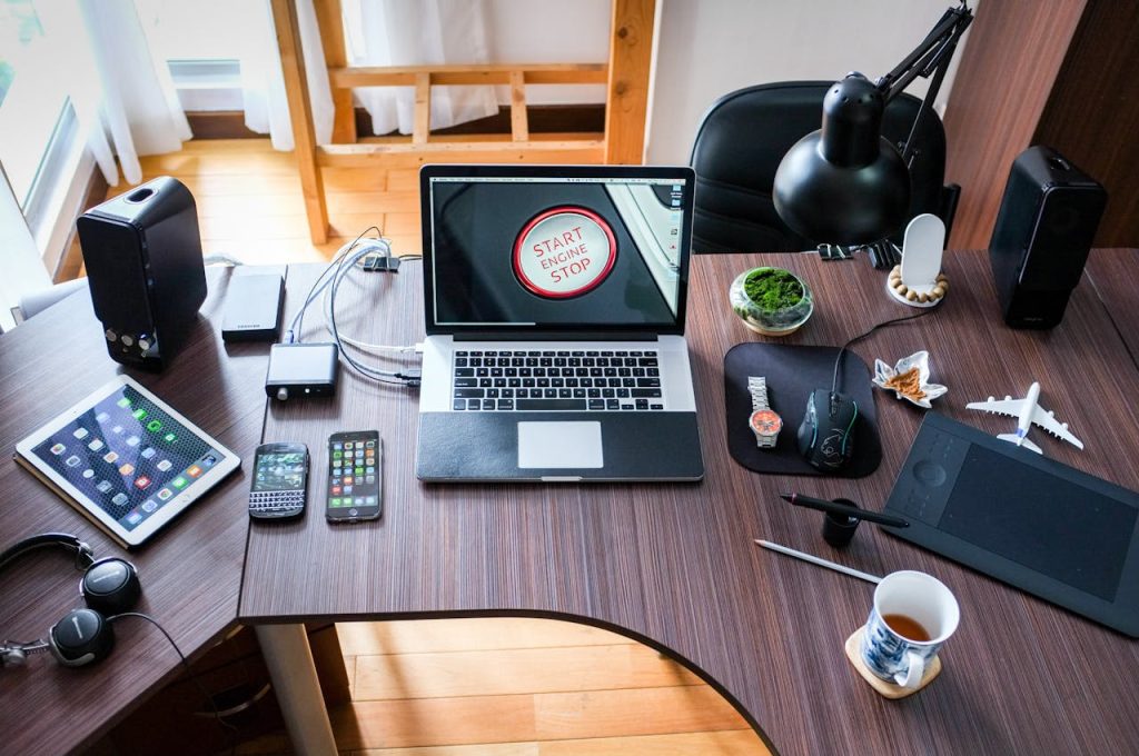 black-and-white-laptop-computer-on-brown-wooden-desk-356056 A contemporary office desk setup with laptops, gadgets, and accessories, creating a tech-savvy workplace.